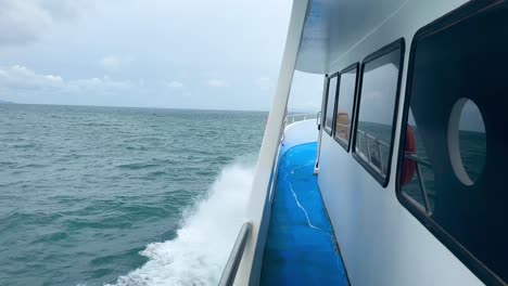 lateral view of ferry running from phuket to phi phi island on a rainy day