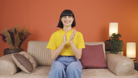 Woman-clapping-excitedly-to-camera.