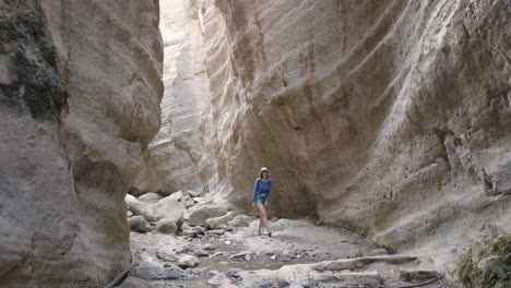 woman hiking through a canyon