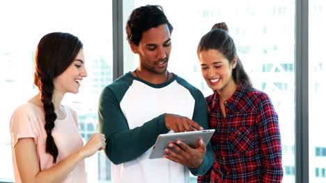 Group-of-executives-discussing-over-digital-tablet