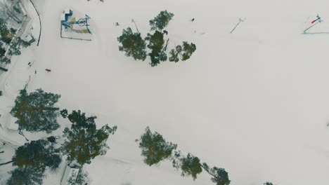 ski resort with lift and people on snowy mountain upper view