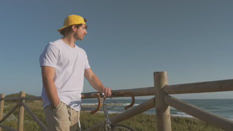 Man-With-Bike-Walking-Down-The-Boardwalk-1