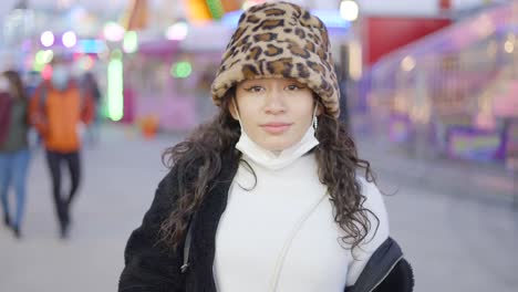 woman at a funfair with a bucket hat