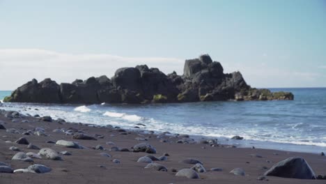 black sand beach with volcanic rocks