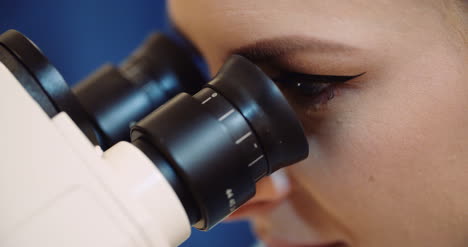 scientist examining bacteria under microscope at laboratory 6