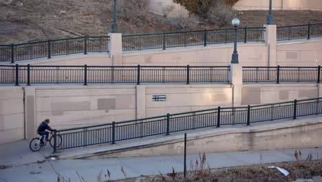 slow motion aerial footage of biker riding on an urban trail