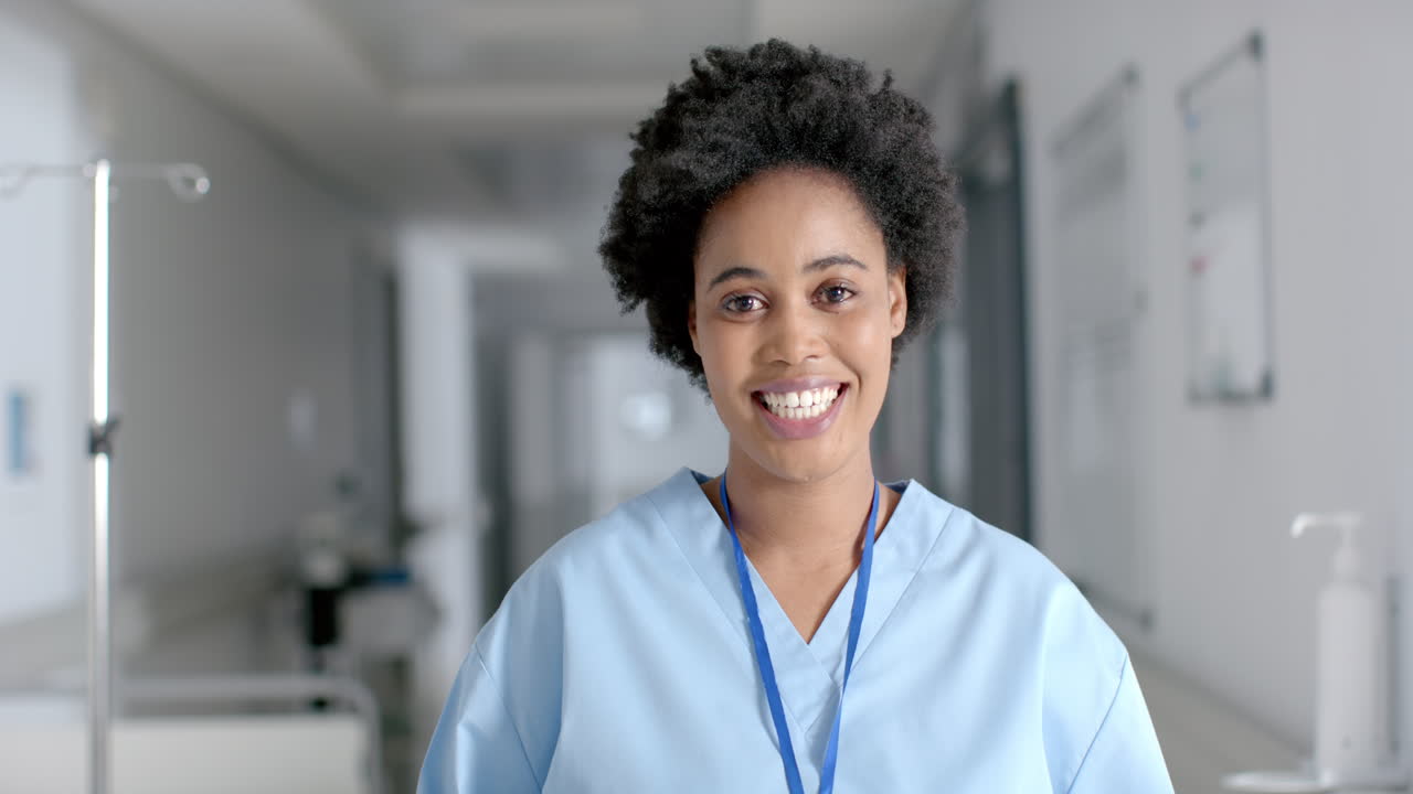 African American nurse smiles brightly in a hospital setting