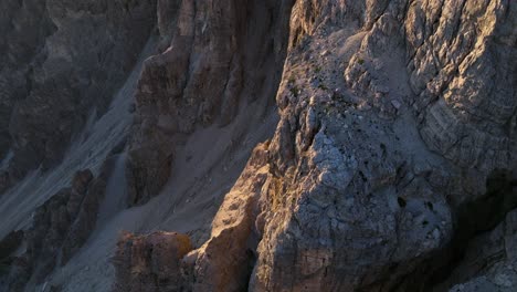 Drone-footage-captures-the-serene-ambiance-of-the-Dolomites-with-the-first-rays-of-the-sun-casting-elongated-shadows-across-the-mountainous-terrain