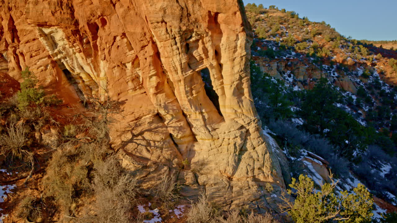 Drone shot of amazing natural arch in red rock landscape at sunrise near Kanab Utah