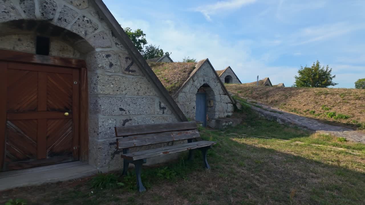 Traditional triangular-gabled entrances of the winery cellars of the Kőporosi Pincesor in Hercegkút, Hungary