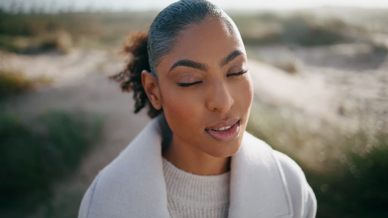 Peaceful model open eyes meditating outdoors closeup. Beautiful african american