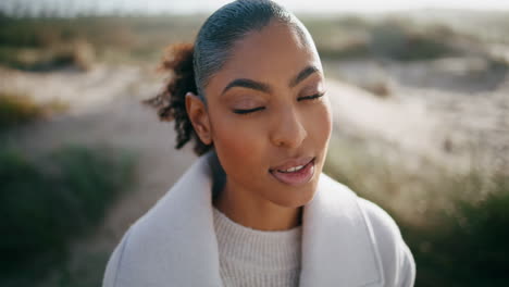 peaceful model open eyes meditating outdoors closeup. beautiful african american