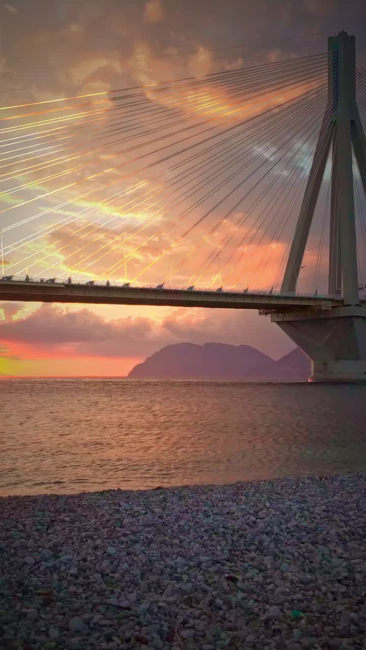 Patras road toll bridge with red sky sunset golden hour backdrop Greece