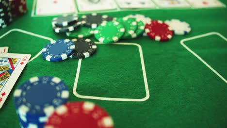 two aces thrown on green casino table - chips-checks-casino token- poker - down shot - slow motion