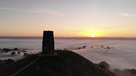 landscape aerial of the misty glastonbury tor at sunrise in somerset