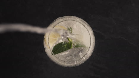 sparkling lemon ice mint cocktail closeup. making cocktail process concept