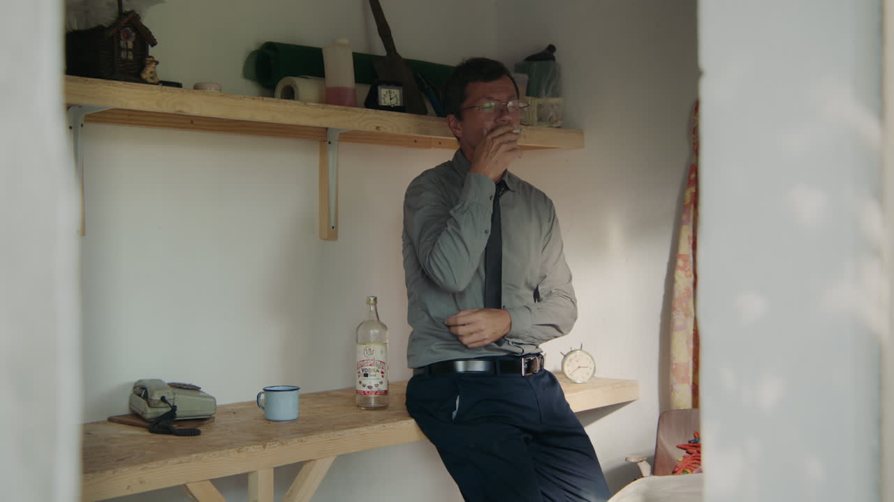 Man Smoking and Stressed in a Shed