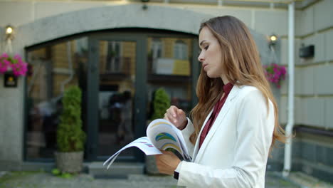 Serious-business-woman-reading-documents-outdoors.-Woman-analyzing-papers