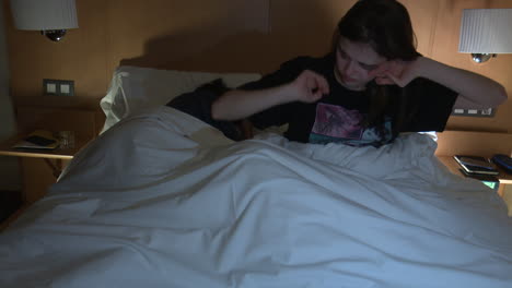 woman arguing with sleeping partner in bed