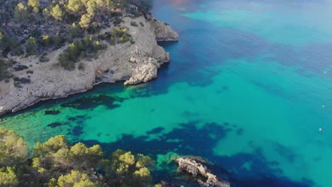 drone flying over a tiny bay on ibiza