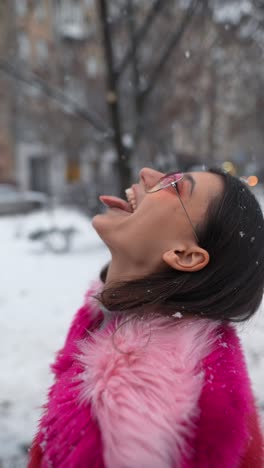 woman enjoying snow in the city