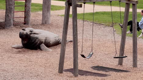 seal statue near swings in a playground