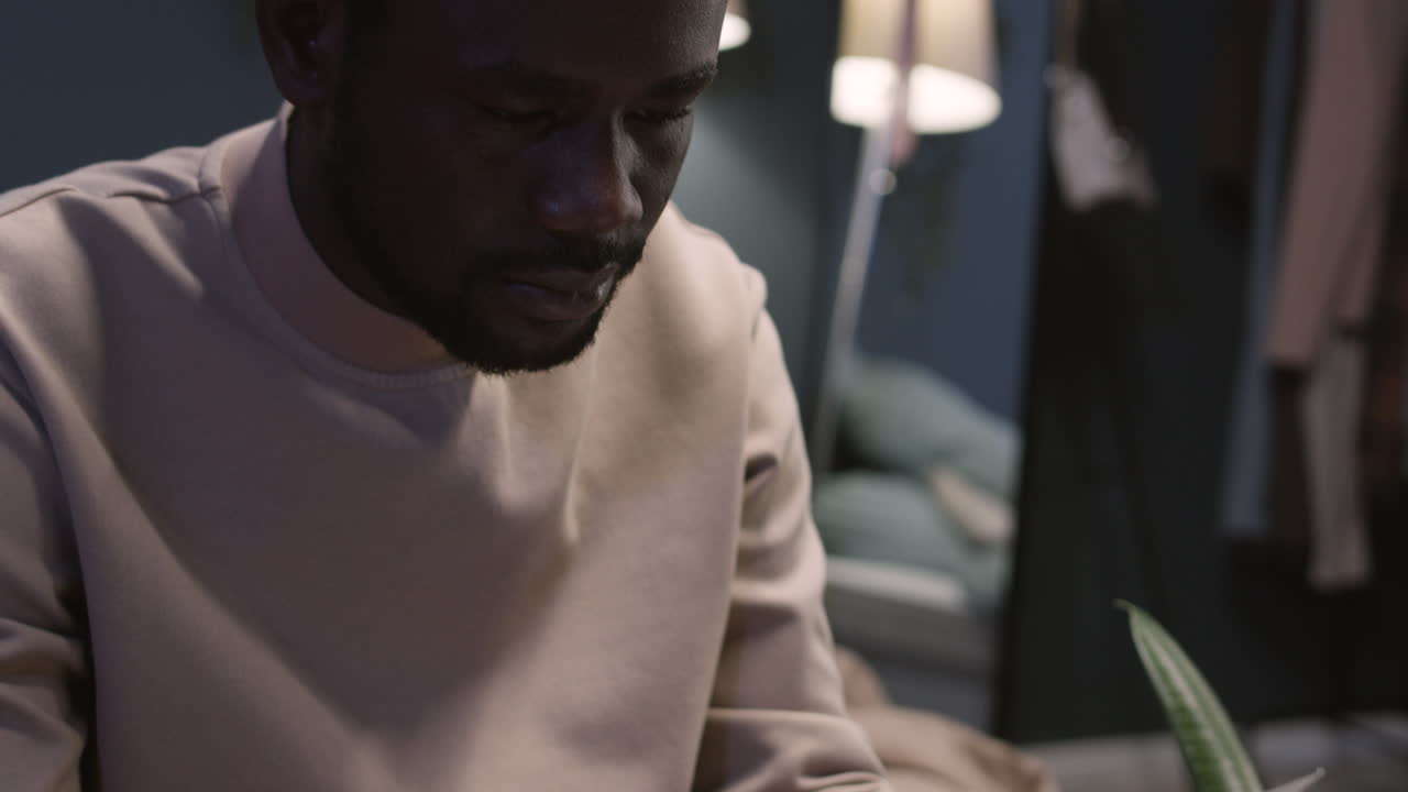 Man opening letter at home