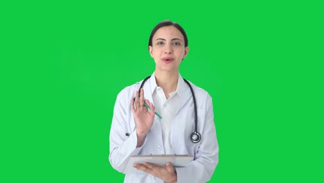 Happy-Indian-female-doctor-talking-to-patient-Green-screen