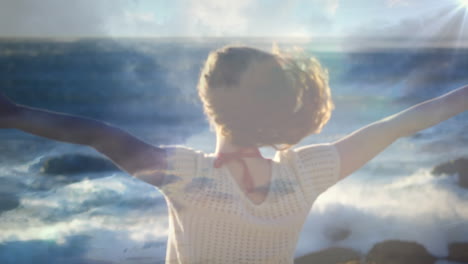 animation of glowing light over woman with stretched arms relaxing in nature against blue sky