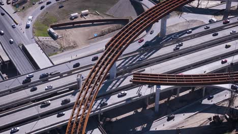 construction resumes along an overpass with steel beams and concrete pillars