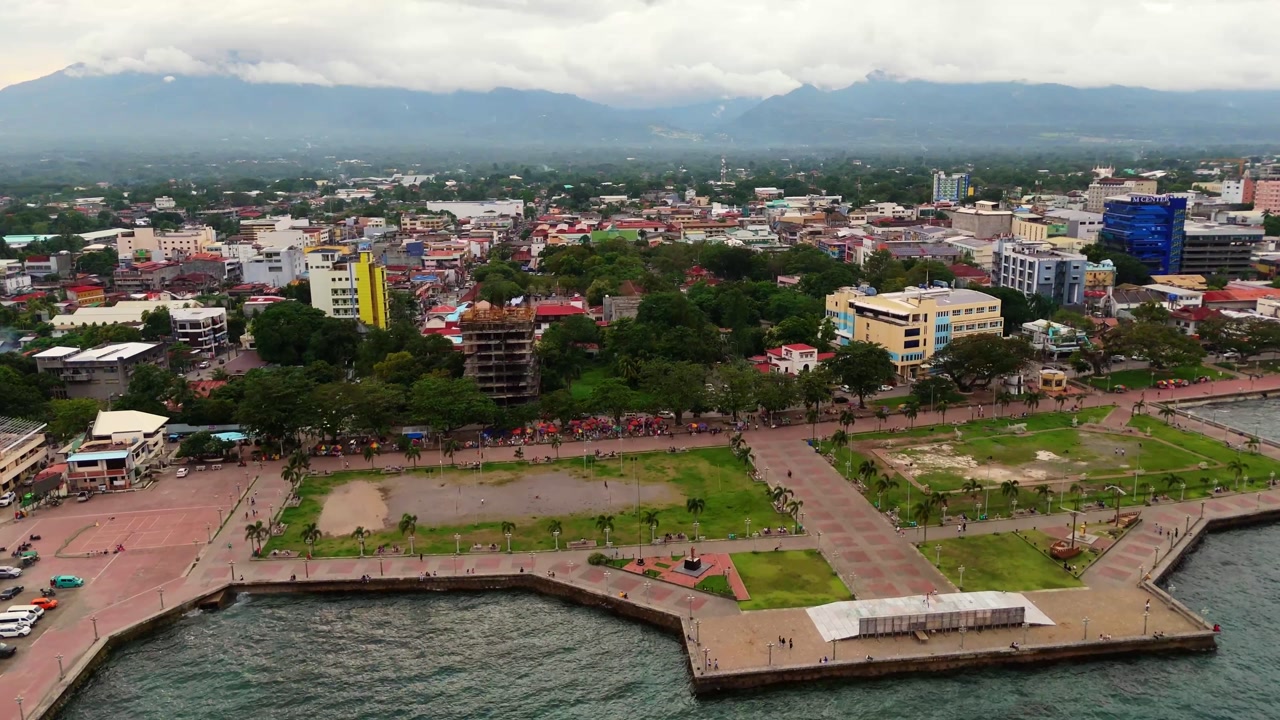 Aerial drone of Dumaguete city waterfront, featuring the iconic pier and tropical urban scenery