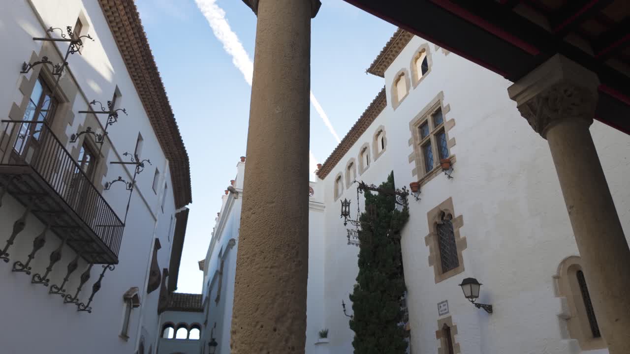 Enchanting view of Maricel Palace in Sitges, Barcelona, highlighting its architectural beauty and historical significance under a blue sky. A perfect blend of culture, heritage, and aesthetic appeal.