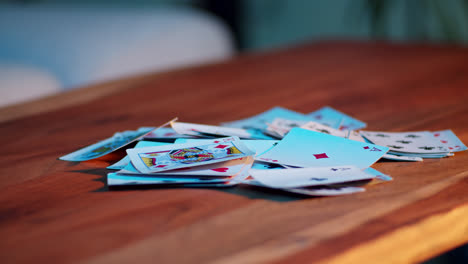 pile of playing cards on a wooden table