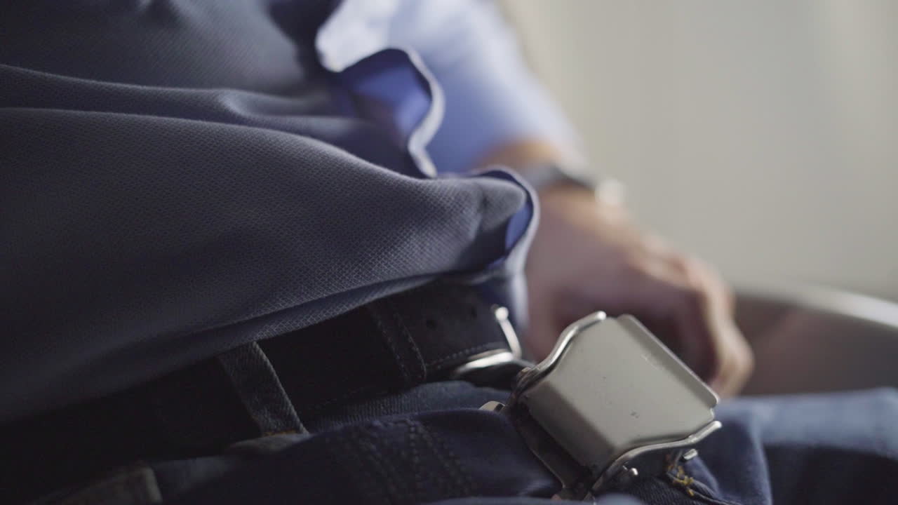 Fastening Seat Belt on Airplane