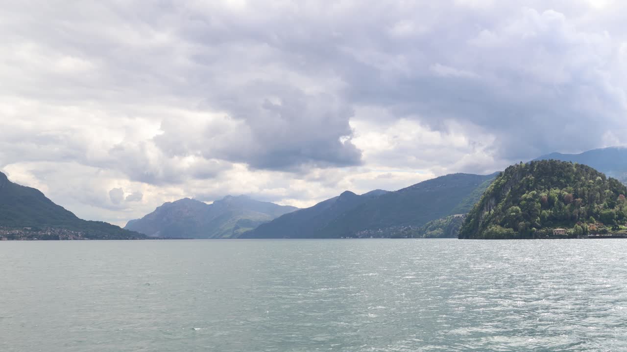 Crossing lake como with dramatic dark clouds in the background, establisher