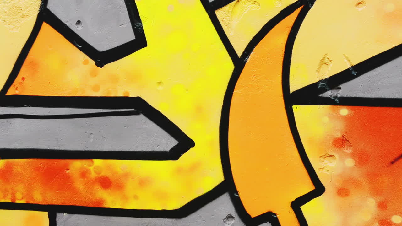 The artist draws graffiti on a fence. Abstract drawing