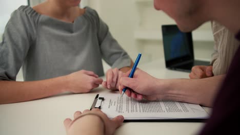 happy male couple sign contract for buy new house with realtor agent