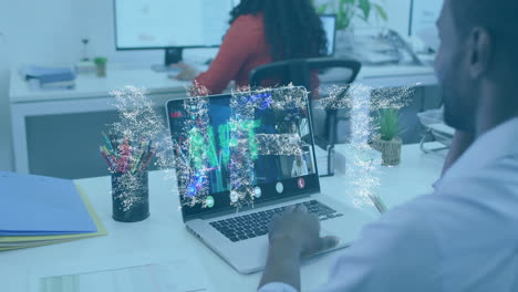 man at desk interacting with laptop in business office, showing floating data chart animations