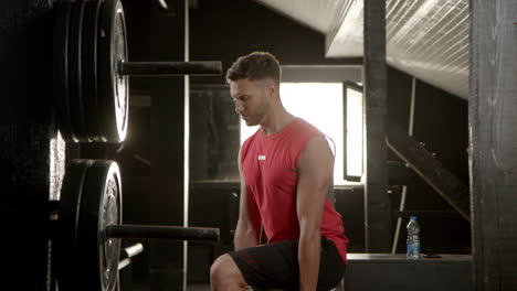 man lifting weights in a gym