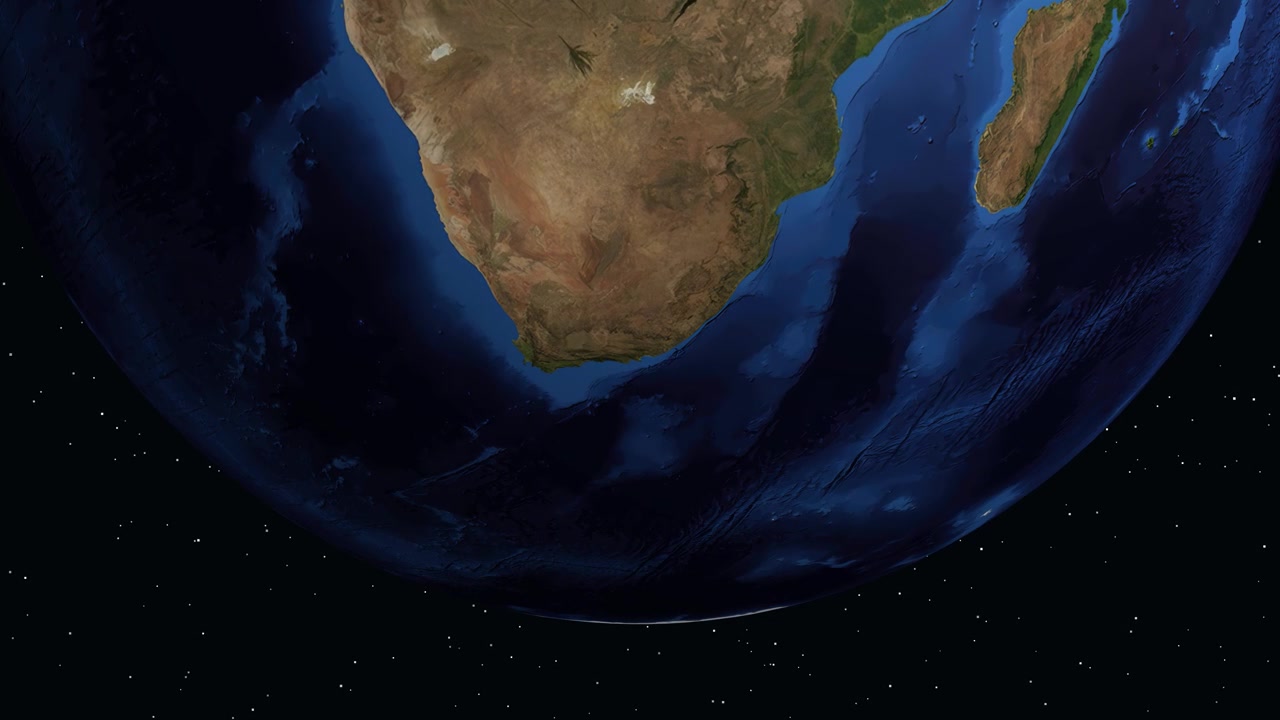 Digital animation zooms from space into Port Elizabeth, South Africa, displaying specific latitude and longitude