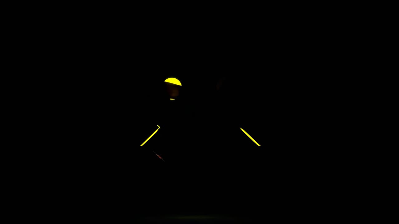 A low-angle video shot of a glowing yellow smiley face on a black background, creating a futuristic