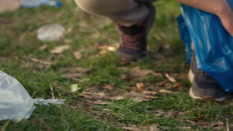 people using proper tools to clean the forest and recycle plastic waste