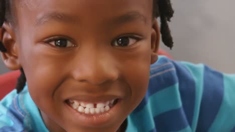 Portrait-of-happy-schoolboy-in-classroom