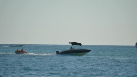 A-family-having-fun-on-a-big-floater-pulled-by-a-sportboat-near-a-resort-in-Mauritius-island