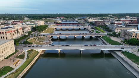 aerial view of des moines, iowa, highlighting the des moines river, prominent bridges, and the historic state capitol building