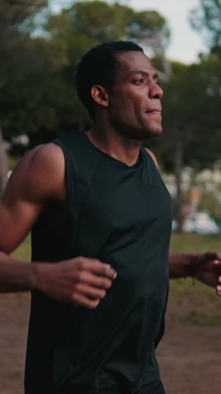 Young Athletic Black Man Warms Up In Park