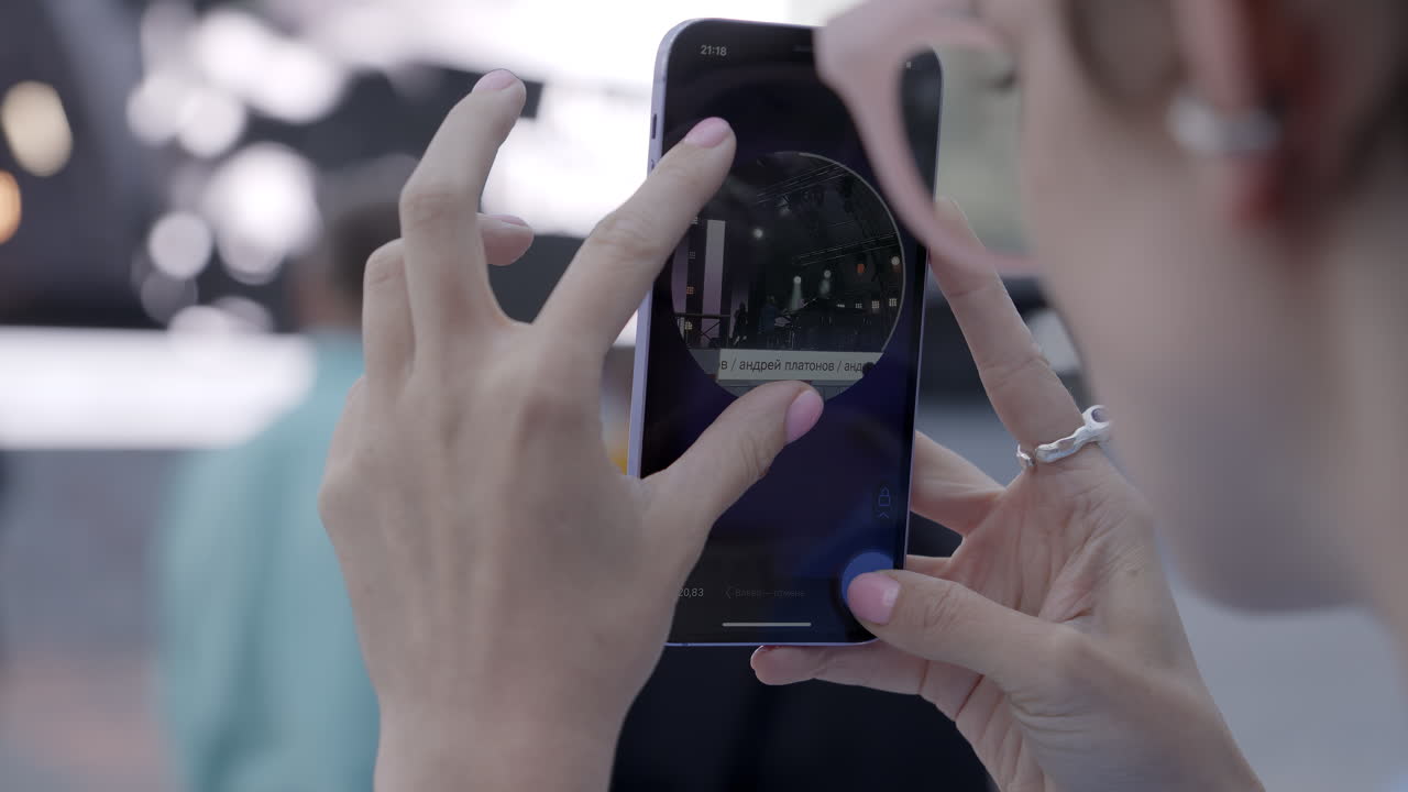 Woman Taking Photo of Event on Smartphone