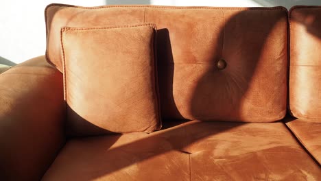 close-up of a brown sofa with pillows