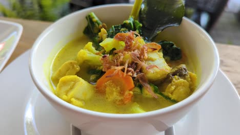 balinese cuisine of tuna fish curry with vegetables and lemongrass in local warung restaurant in bali indonesia