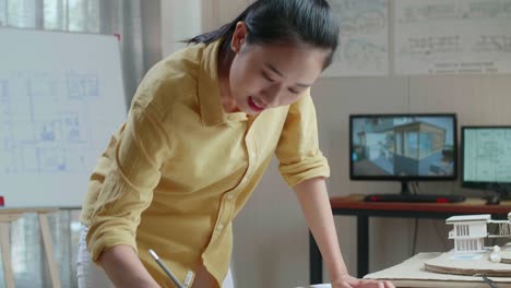 woman architect working on house plans